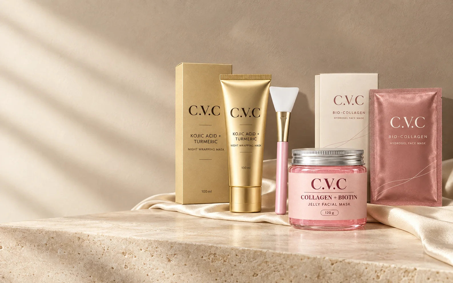 The C.V.C mask collection: champagne gold wrapping mask, blush jelly mask and rose hydrogel mask, styled on ivory stone